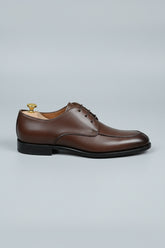 Brown leather lace-up dress shoes with classic design for formal occasions.